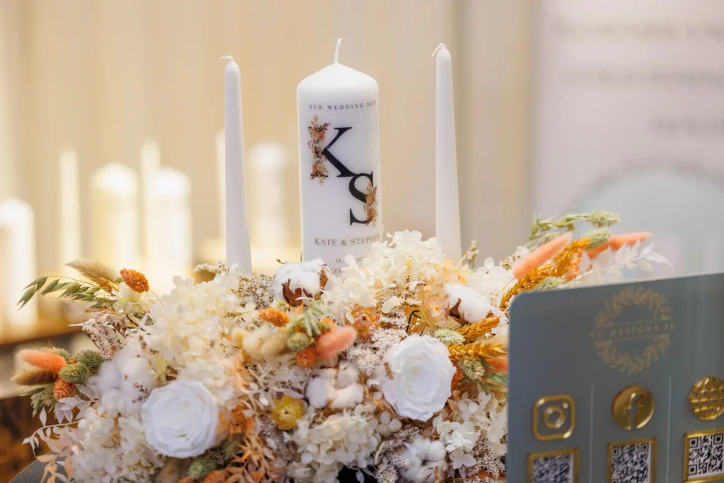 Elegant wedding candle display with floral arrangement and QR code offer a blend of tradition and modernity.